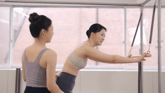 Woman taking a break during a challenging pilates session