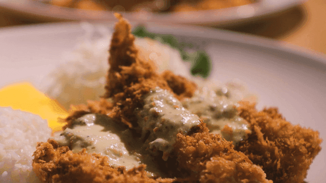 Fish cutlet served with sauce and rice