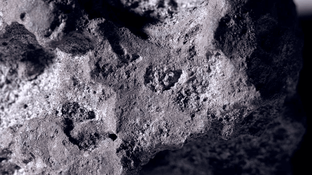 Surface of a dark rock illuminated by light
