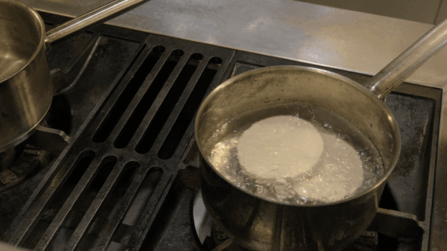 Pot of boiling water with vegetables