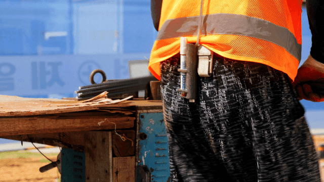 Construction worker handling rebar