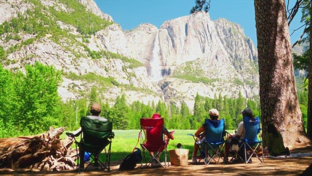 People Enjoying Scenic Waterfall Outdoors