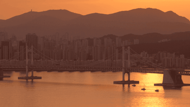 Sunset view of a city skyline and bridge