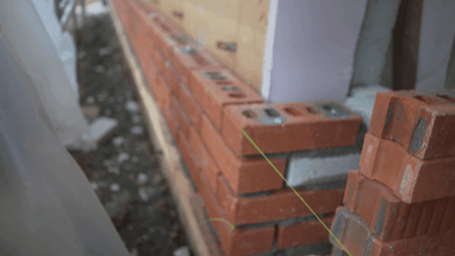 Brick wall construction site aligned with string