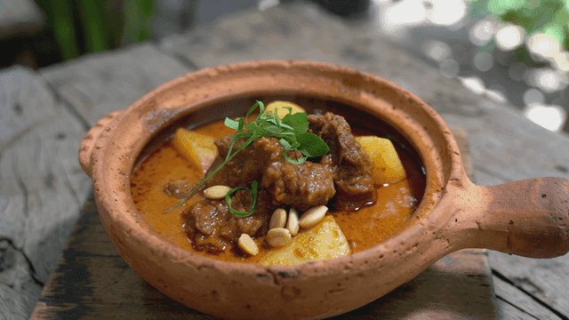 Hot Massaman curry stew topped with herbs