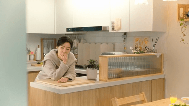 Woman deep in thought in a kitchen