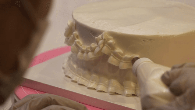 Decorating a cake with white icing