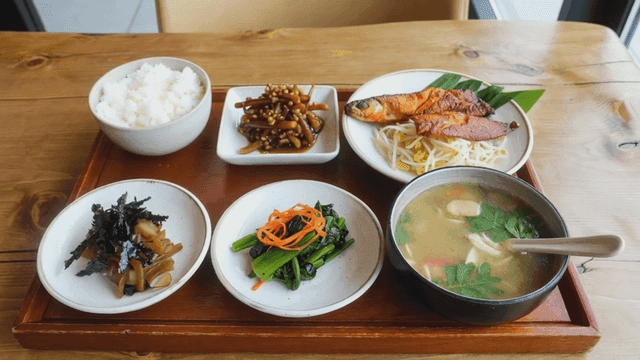 Full Korean meal set with grilled fish and various side dishes