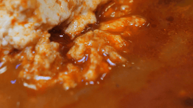 Spicy tofu stew simmering in a pot