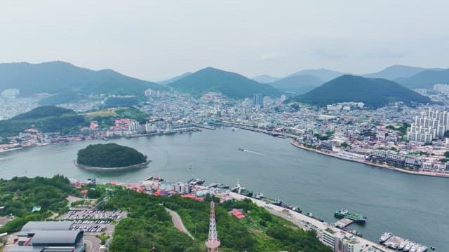 Scenic view of a coastal city with mountains