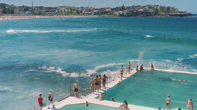 Beach Swimming Pool Crowded with People Enjoying Water Activities