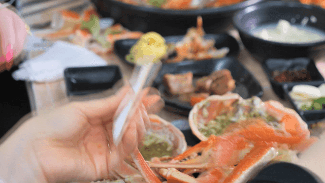 People who split open steamed crab legs to eat