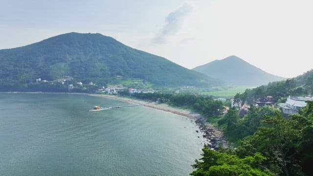 Coastal village with lush green mountains