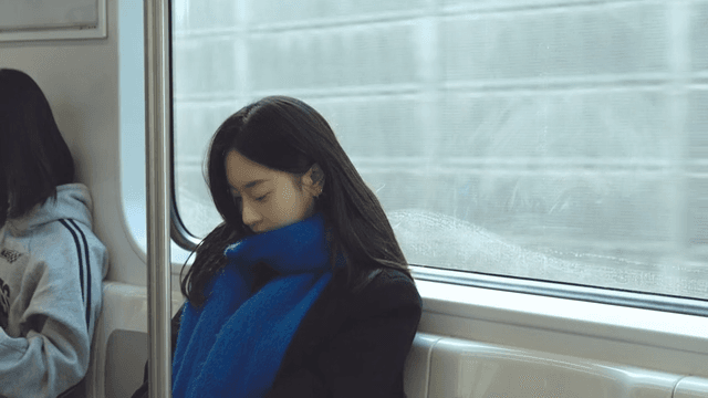 Woman dozing off while sitting on the subway