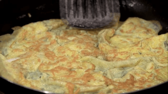 Flipping thin egg sheet over a pan
