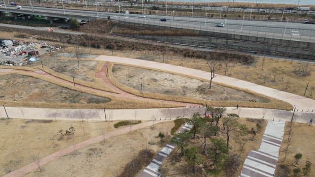 Park with pathways near a highway