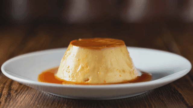 Creamy flan pudding dessert served on white plate