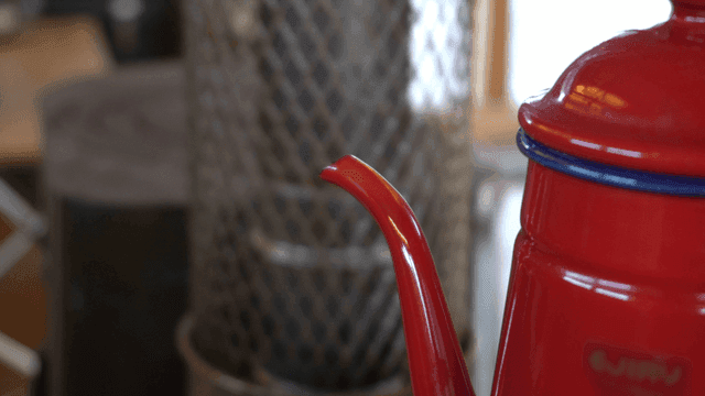 하얀 증기가 흘러나오는 붉은 주전자의 주둥이