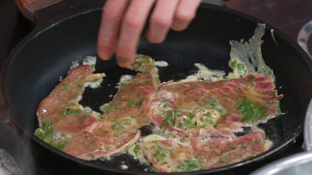 Pan-fried Battered Beef cooked deliciously in oil in a frying pan