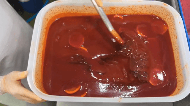 Mixing red broth in a container