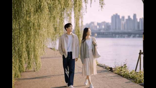 Couple walking along riverside path