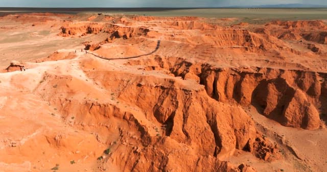 Expansive red desert landscape with cliffs