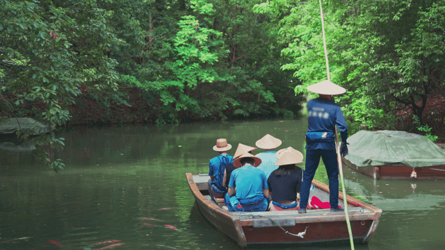People on a boat ride through a lush forest