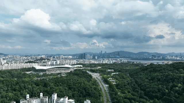 Vast city landscape with stadiums and greenery
