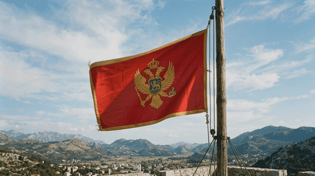 Montenegrin flag fluttering on hill and scenery