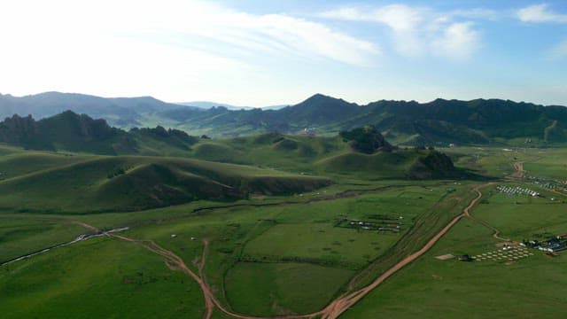 Expansive green hills and distant mountains