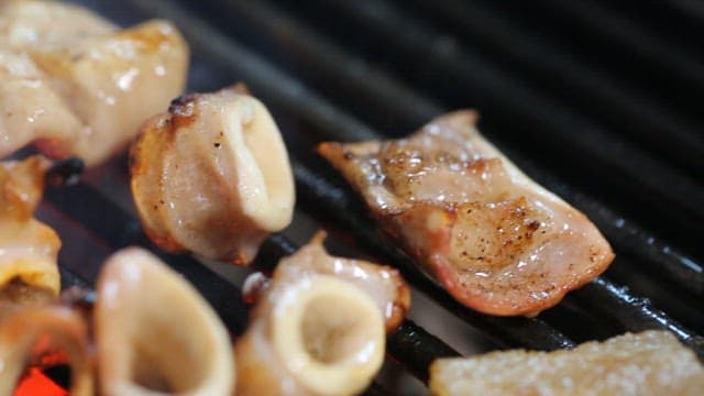 Gular sack of pork intestines sizzling on the grill