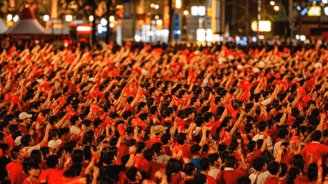 Large crowd cheering at night