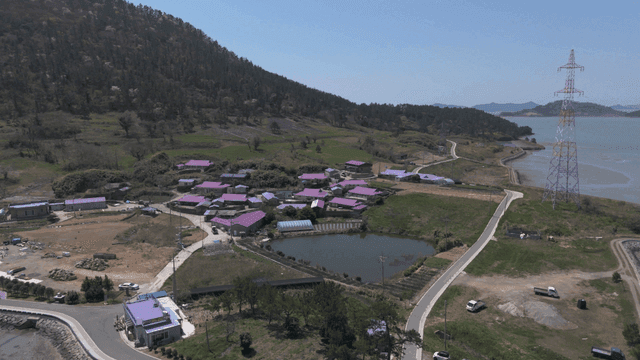 Beautiful country village with purple roofs by sea