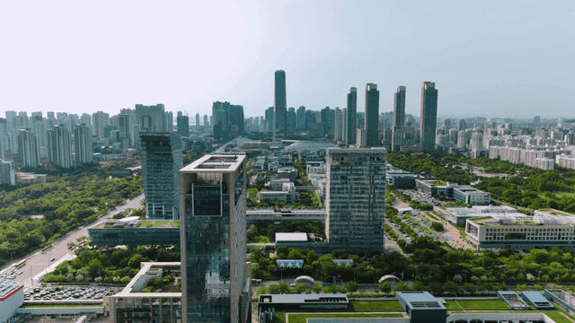 Modern city with high-rise buildings and greenery.