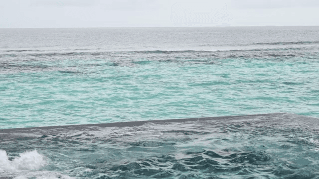 Calm ocean waves under a cloudy sky