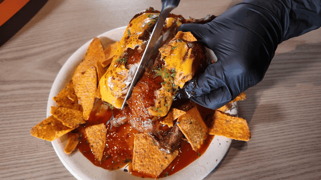 Chicken slicer topped with nachos and cheese