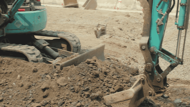 Excavator moving soil at a construction site