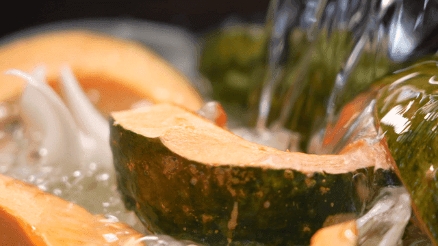 Water pouring over sliced vegetables