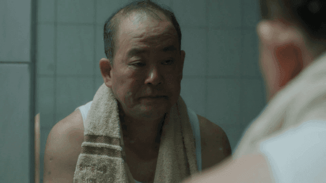 Man looking in mirror in bathroom