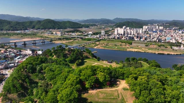 Cityscape with a river and green forest