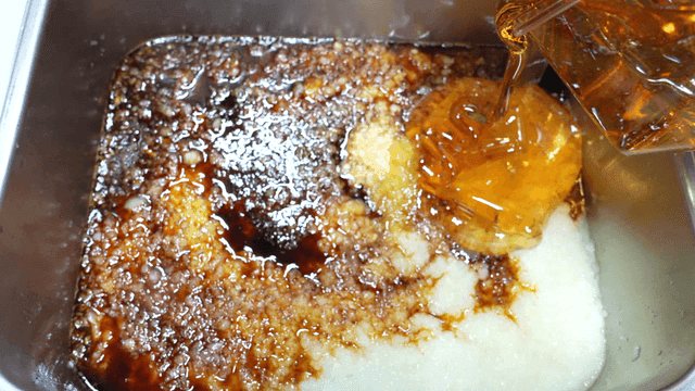 Honey and soy sauce seasoning mixed in metal tray