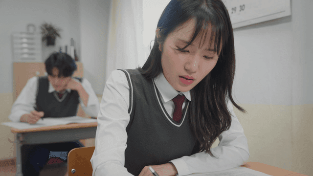 입술을 깨물며 시험에 집중하는 학생