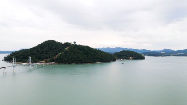 View of lush green island surrounded by calm sea