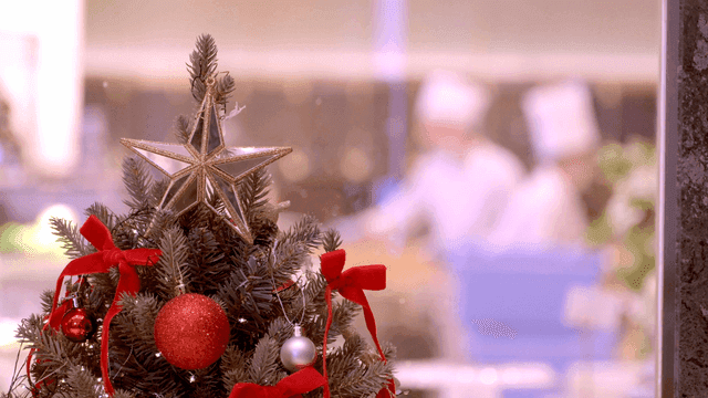 Decorated Christmas tree with chefs vaguely visible