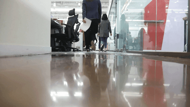 Office hallway with people walking