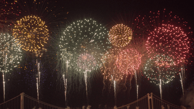 불빛이 켜진 다리 위의 화려한 불꽃놀이