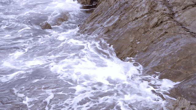waves crashing against rocky shore