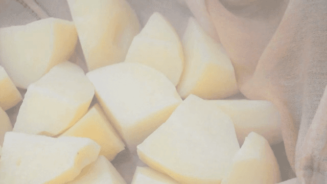 Potatoes being steamed in a pot
