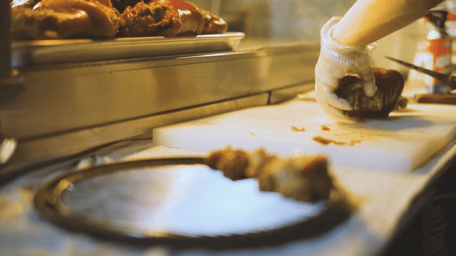 Slicing of braised pig's feet on a board