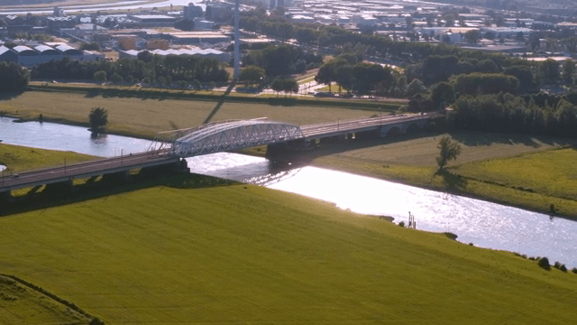 Bridge over a river with green fields